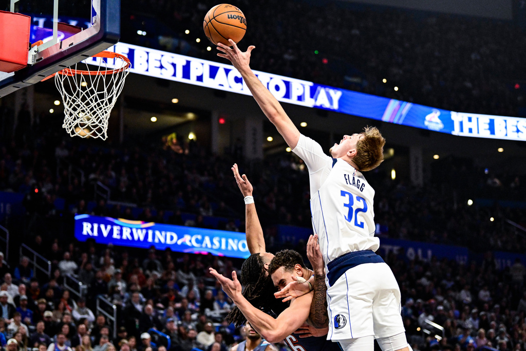Dallas Mavericks forward Cooper Flagg (32) shoots against Oklahoma City Thunder during the first half of an NBA basketball game, Friday, Dec. 5, 2025, in Oklahoma City. (AP Photo/Gerald Leong)