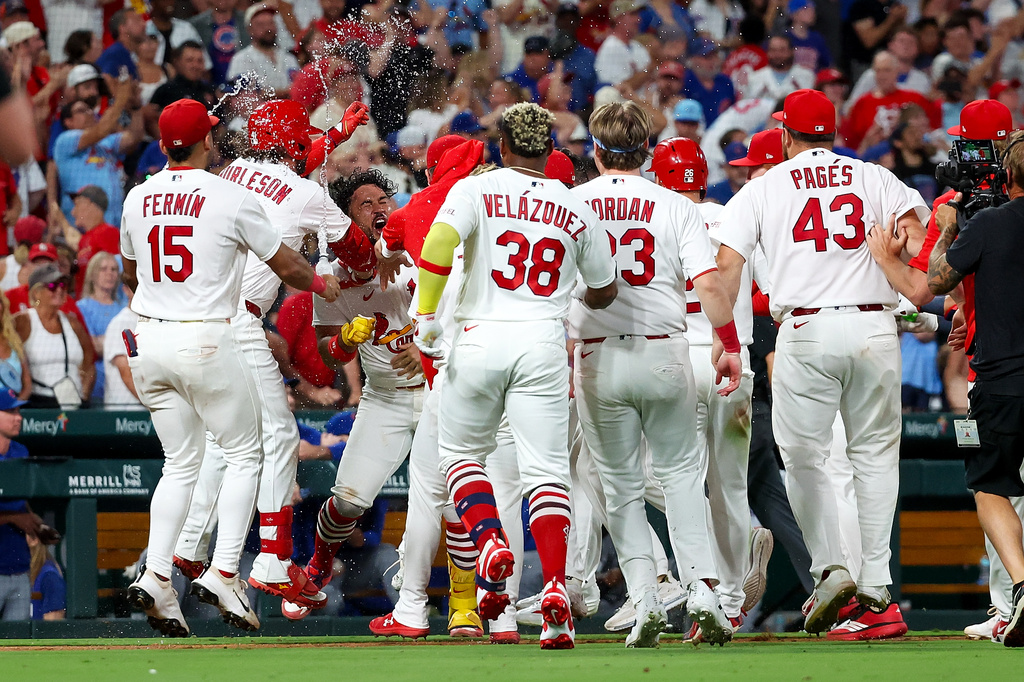 St. Louis Cardinals' Iván Herrera is mobbed by teammates as they celebrate his walk-off double during the tenth inning of a baseball game against the Chicago Cubs, Wednesday, July 29, 2026, in St. Louis. (AP Photo/Scott Kane)