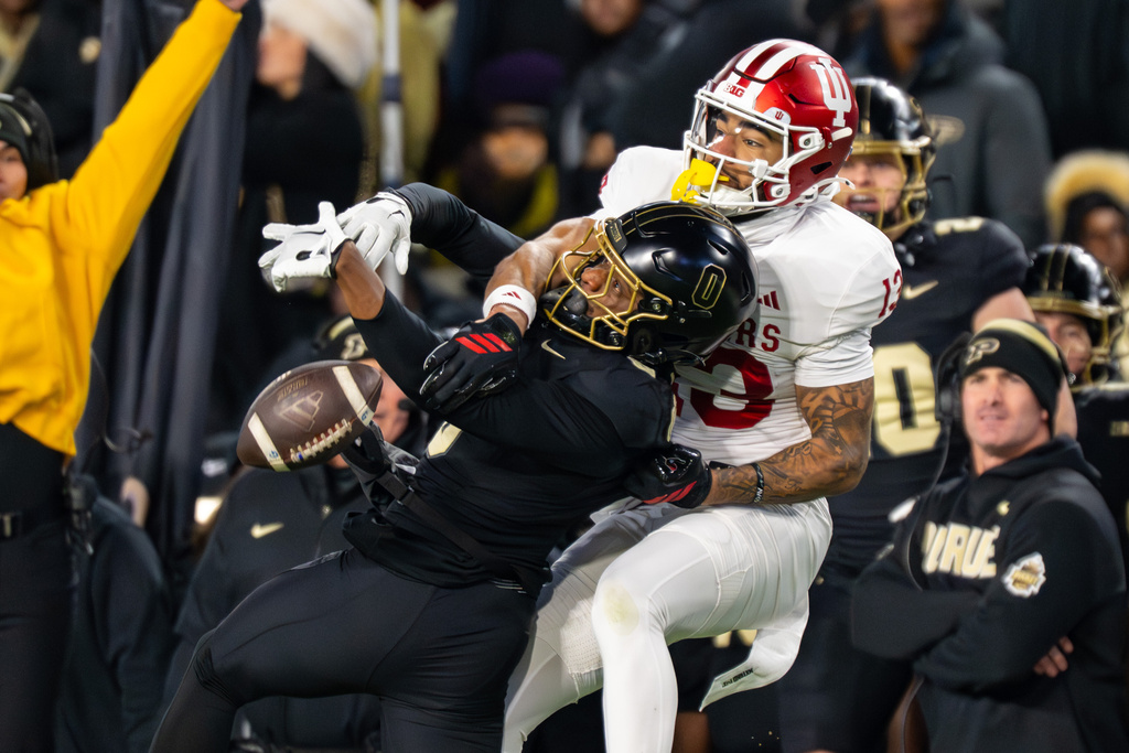 Indiana linebacker Kellan Wyatt (13) breaks up a pass intended for Purdue wide receiver Nitro Tuggle, left, during the first half of an NCAA college football game, Friday, Nov. 28, 2025, in West Lafayette, Ind. (AP Photo/Doug McSchooler)