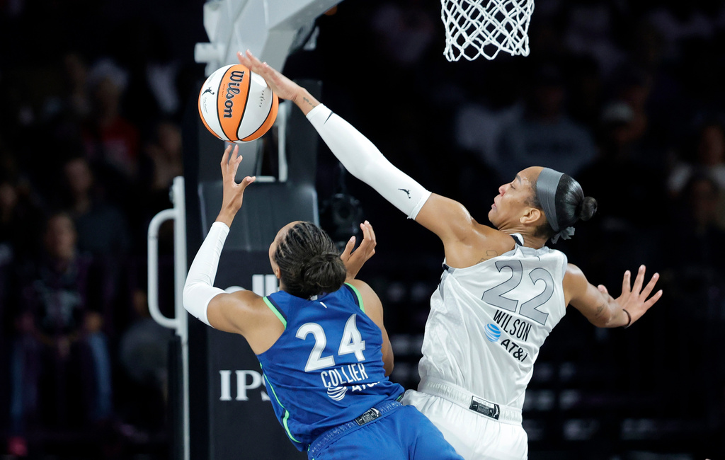 Las Vegas Aces center A'ja Wilson (22) blocks a shot by Minnesota Lynx forward Napheesa Collier (24) during the first half of a WNBA basketball game Saturday, Aug. 15, 2026, in Las Vegas. (Steve Marcus/Las Vegas Sun via AP)