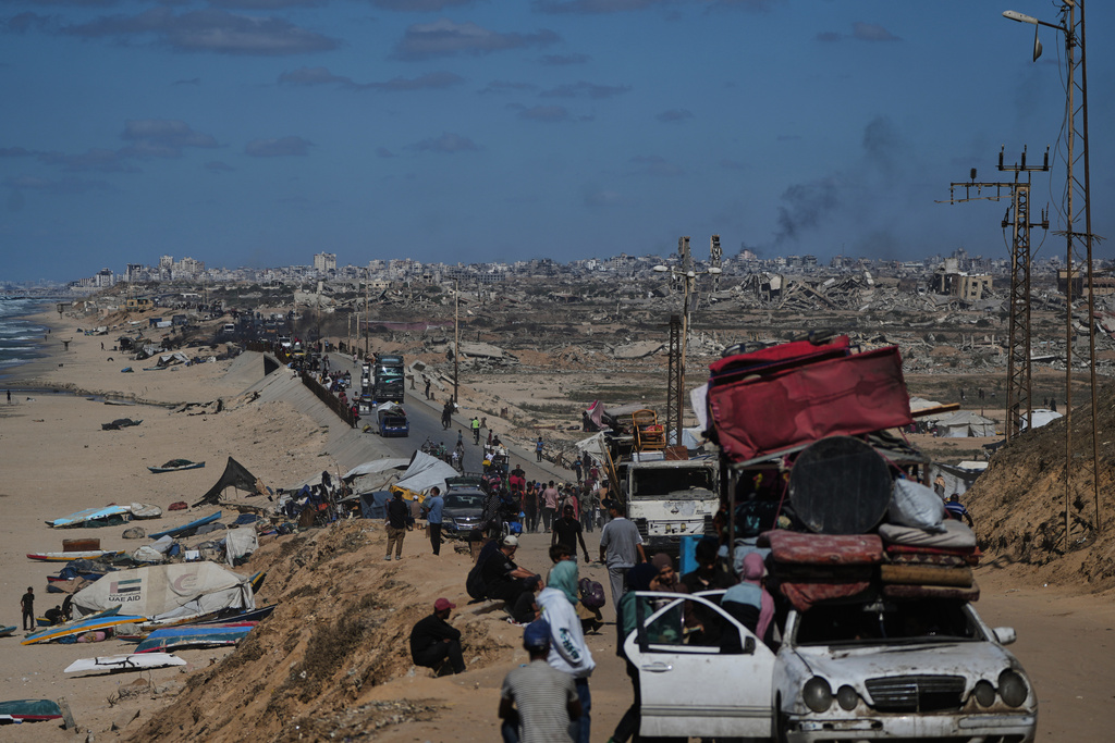 Displaced Palestinians flee northern Gaza carrying their belongings along the coastal road near Wadi Gaza, Wednesday, Oct, 1, 2025. (AP Photo/Abdel Kareem Hana)