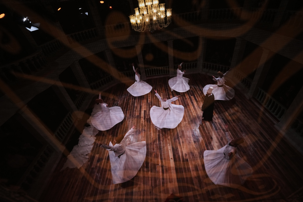 Whirling dervishes of the Mevlevi order perform during a Sheb-i Arus ceremony at Kasimpasa Mevlevihane in Istanbul, Turkey, Thursday, Dec. 11, 2025, to commemorate the death of 13th century Islamic scholar, poet and Sufi mystic Jalaladdin Rumi. (AP Photo/Francisco Seco)