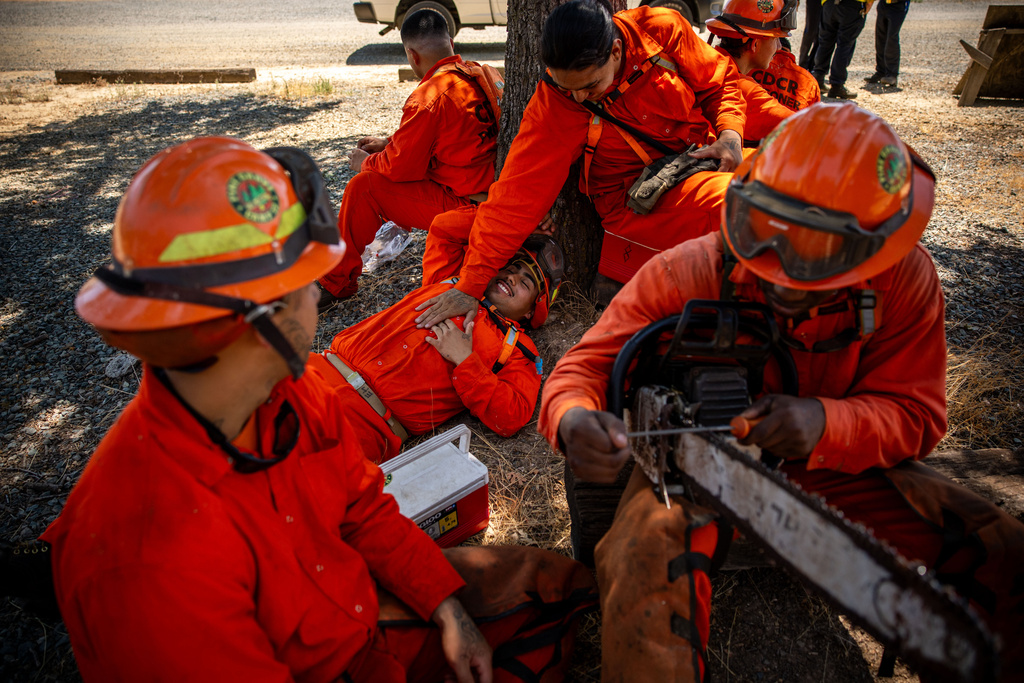 Pine Grove Youth Conservation Camp inmates take a lunch break, July 14, 2025, near Ione, Calif. (AP Photo/Ethan Swope)