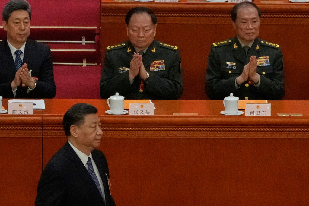 Chinese President Xi Jinping, bottom left, walks past then Vice Chairmen of China's Central Military Commission Zhang Youxia, top center, and He Weidong, top right, during a session of the National People's Congress (NPC) at the Great Hall of the People, in Beijing, China, March 12, 2023. (AP Photo/Andy Wong)