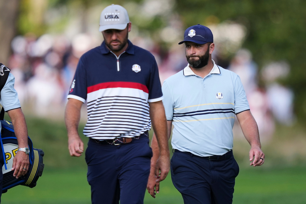 United States' Scottie Scheffler and Europe's Jon Rahm walk on the 13th hole at Bethpage Black golf course during the Ryder Cup golf tournament, Friday, Sept. 26, 2025, in Farmingdale, N.Y. (AP Photo/Matt Slocum)