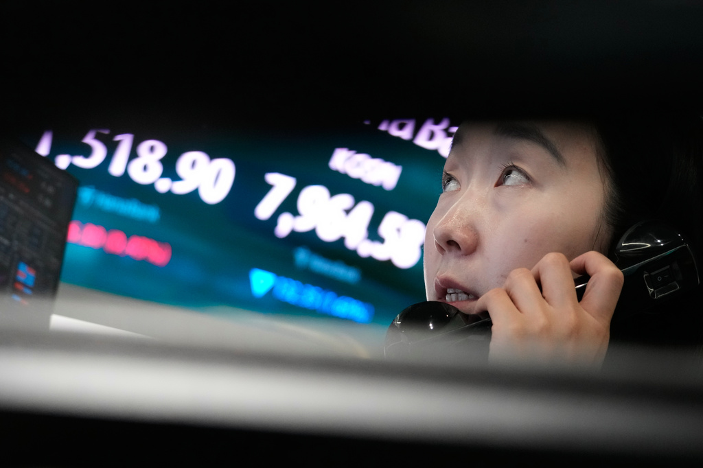 A currency trader talks on the phone near a screen showing the Korea Composite Stock Price Index (KOSPI) and the foreign exchange rate between U.S. dollar and South Korean won at the foreign exchange dealing room of the Hana Bank headquarters in Seoul, South Korea, Wednesday, June 10, 2026. (AP Photo/Ahn Young-joon)