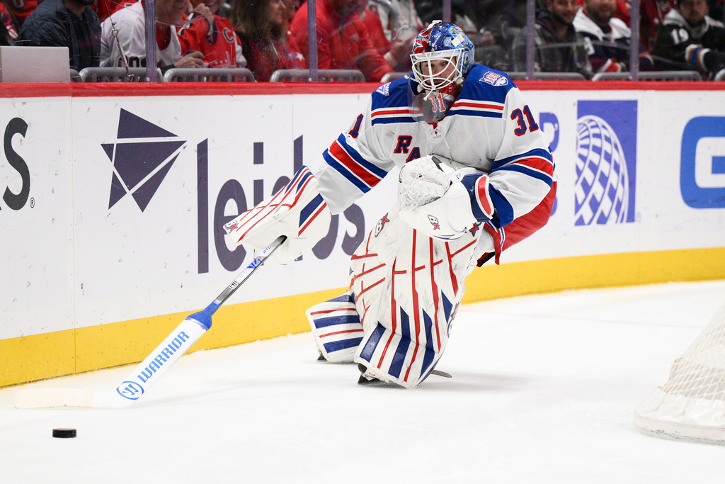 New York Rangers goaltender Igor Shesterkin (31) chases the puck during the first period of an NHL hockey game against the Washington Capitals, Tuesday, Dec. 23, 2025, in Washington. (AP Photo/Nick Wass)