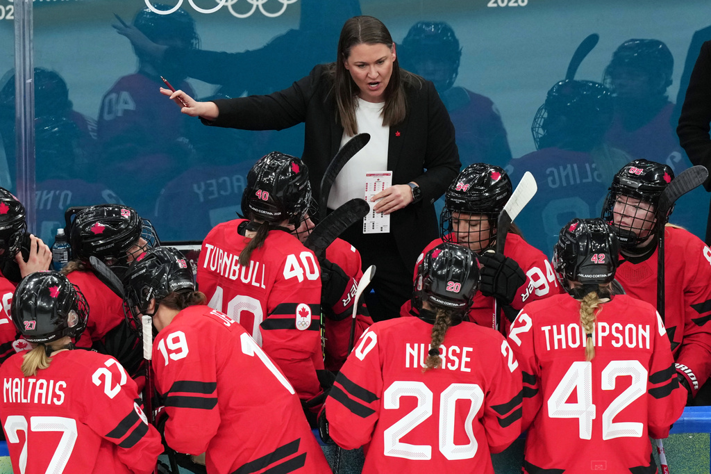 FILE - Canada assistant coach Kori Cheverie talks with her players during the first period of a women's ice hockey semifinal match against Switzerland at the 2026 Winter Olympics in Milan, Feb. 16, 2026. (AP Photo/Carolyn Kaster, File)