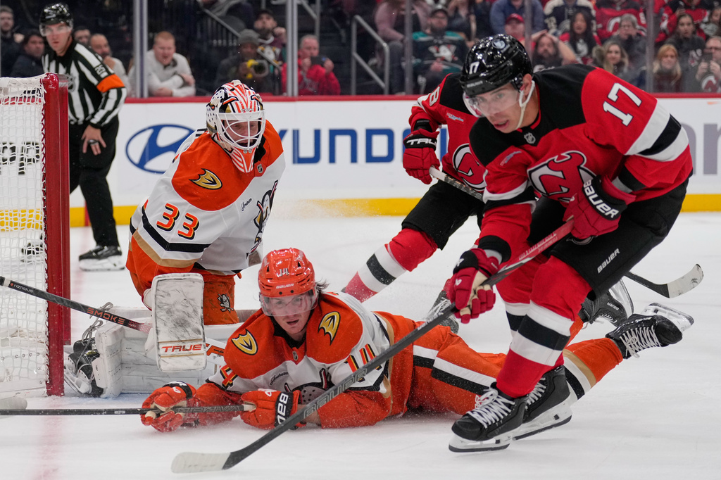 Anaheim Ducks goaltender Ville Husso, left, defends the net during the second period of an NHL hockey game against the New Jersey Devils in Newark, N.J., Thursday, Oct. 22, 2026. (AP Photo/Seth Wenig)