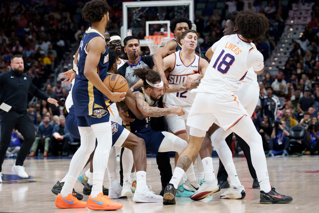 New Orleans Pelicans guard Jose Alvarado (15) and Phoenix Suns center Mark Williams get into a scrum during the third quarter before both were ejected during an NBA basketball game in New Orleans, Saturday, Dec. 27, 2025. (AP Photo/Matthew Hinton)