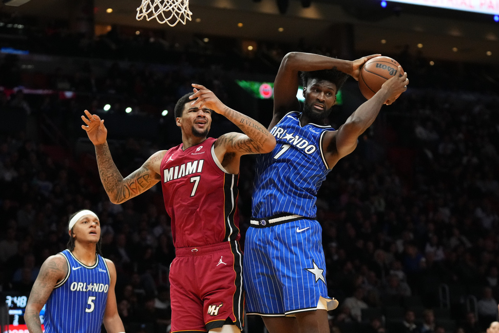 Orlando Magic forward Jonathan Isaac (1) grabs a rebound after Miami Heat center Kel'el Ware (7) missed the basket during the second half of an NBA basketball game Wednesday, Jan. 28, 2026, in Miami. (AP Photo/Marta Lavandier)