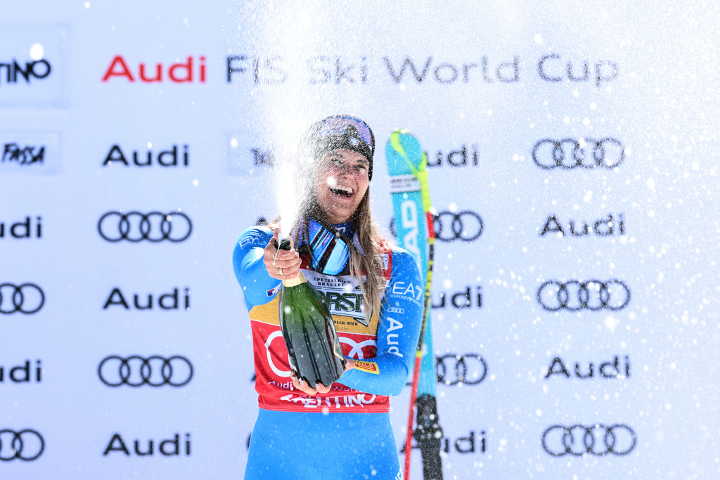 Italy's Laura Pirovano celebrates on the podium after winning an alpine ski, women's World Cup downhill, in Val di Fassa, Italy, Saturday, March 7, 2026. (AP Photo/Marco Trovati)