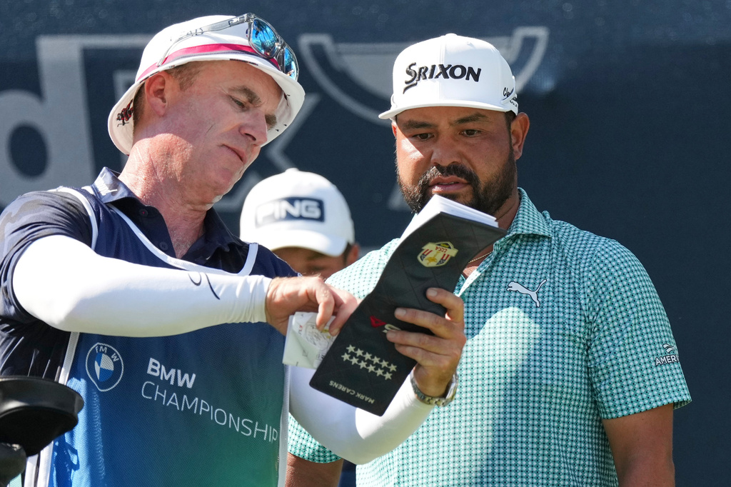 J.J. Spaun, right, talks to his caddie Mark Carens, right, on the 16th tee during the first round of the BMW Championship golf tournament Thursday, Aug. 20, 2026, in St. Louis. (AP Photo/Jeff Roberson)