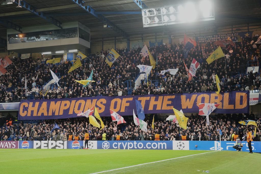 Chelsea fans display a banner reads "Champions of the World" during the Champions League soccer match between Chelsea and Paris Saint-Germain in London, England, Tuesday, March 17, 2026. (AP Photo/Kin Cheung)