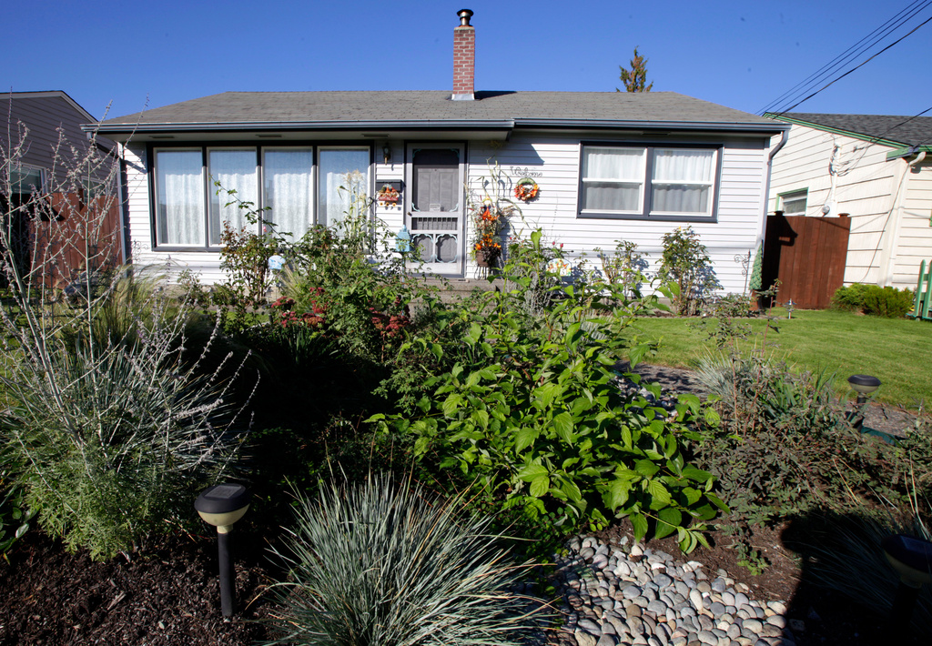 FILE - A rain garden appears in a residential area of Puyallup, Wash., on Oct. 18, 2011. (AP Photo/Ted S. Warren, File)