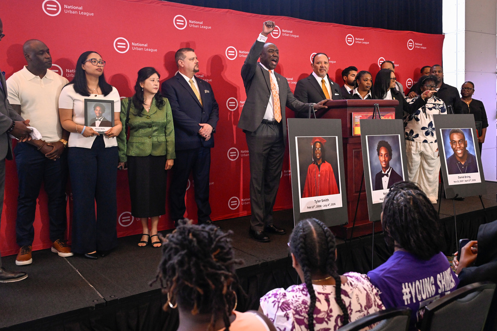 Attorney Ben Crump shouts from the podium as he joins Christine Wonsley and Elmore Wonsley, left, mother and step father of Nolan Wells appear at the National Urban League's annual conference, to share updates on the deaths of their son as well as Daniel Erving, and Tyler Smith, Thursday, July 30, 2026, in Nashville, Tenn. (AP Photo/John Amis)