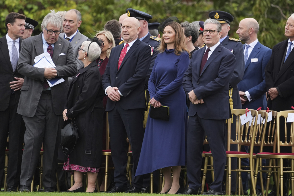 From front right, Britain's Prime Minister Keir Starmer, his wife Victoria Starmer and Britain's Defense Secretary John Healey take their places to watch a Beating Retreat musical performance on the East Lawn of Windsor Castle, in Windsor, England, Wednesday, Sept. 17, 2025. (AP Photo/Evan Vucci)