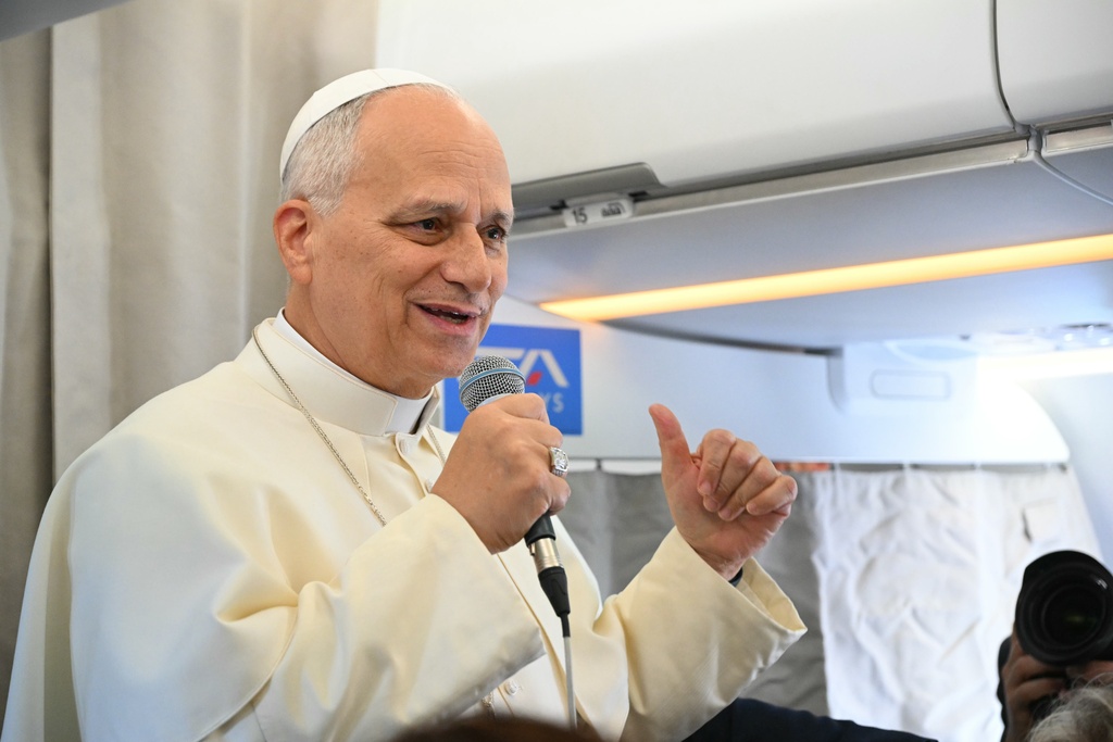 Pope Leo XIV talks to reporters aboard an aircraft on his way to Beirut, Lebanon, Sunday, Nov. 30, 2025. (Andreas Solaro/Pool Via AP)