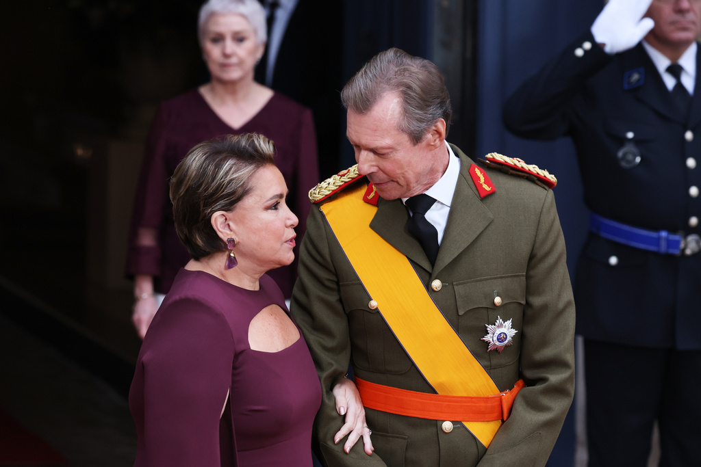 Luxembourg's Grand Duke Henri, right, speaks with Grand Duchess Maria Teresa as they wait for the arrival of guests for the abdication and enthronement ceremony of the Grand Duke of Luxembourg at the Grand Ducal Palace in Luxembourg, Friday, Oct. 3, 2025. (AP Photo/Omar Havana)
