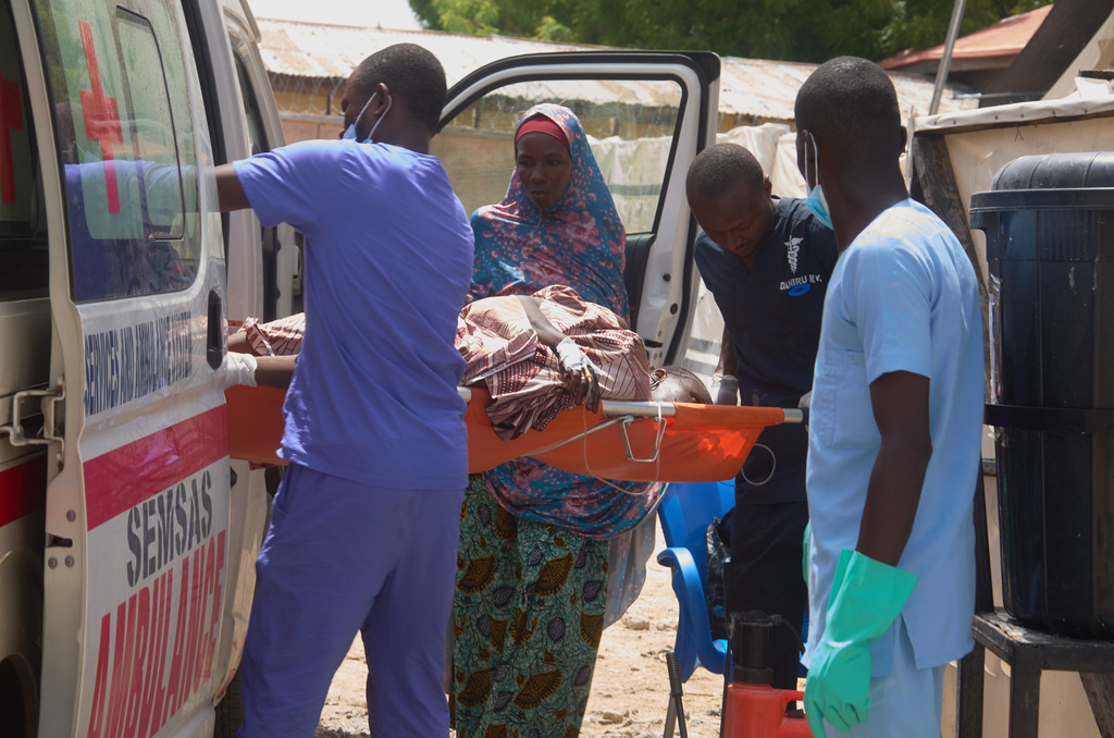 Doctors carry a patient suffering from cholera for treatment at the MSF treatment centre in Maiduguri, Nigeria, Monday, June 8, 2026. (AP Photo/Jude Mike)