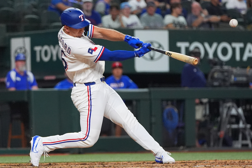 Texas Rangers' Wyatt Langford launches a home run during the fifth inning of a baseball game against the Chicago White Sox, Tuesday, July 21, 2026, in Arlington, Texas. (AP Photo/LM Otero)