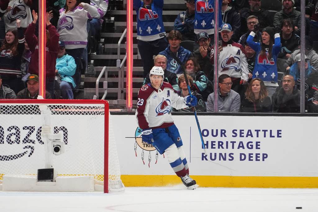 Colorado Avalanche center Nathan MacKinnon looks on after scoring an empty net goal against the Seattle Kraken during the third period of an NHL hockey game Tuesday, Dec. 16, 2025, in Seattle. (AP Photo/Lindsey Wasson)