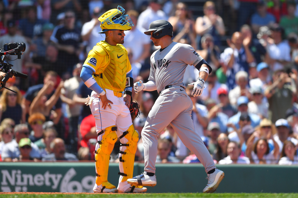 New York Yankees' Max Schuemann, right, scores on his home run in front of Boston Red Sox catcher Carlos Narváez, left, in the fifth inning of a baseball game, Saturday, June 27, 2026, in Boston. (AP Photo/Steven Senne)