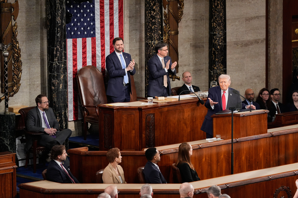 Vice President JD Vance, left, and House Speaker Mike Johnson applaud President Donald Trump during his State of the Union address to a joint session of Congress in the House chamber at the U.S. Capitol in Washington, Tuesday, Feb. 24, 2026. (AP Photo/Alex Brandon)