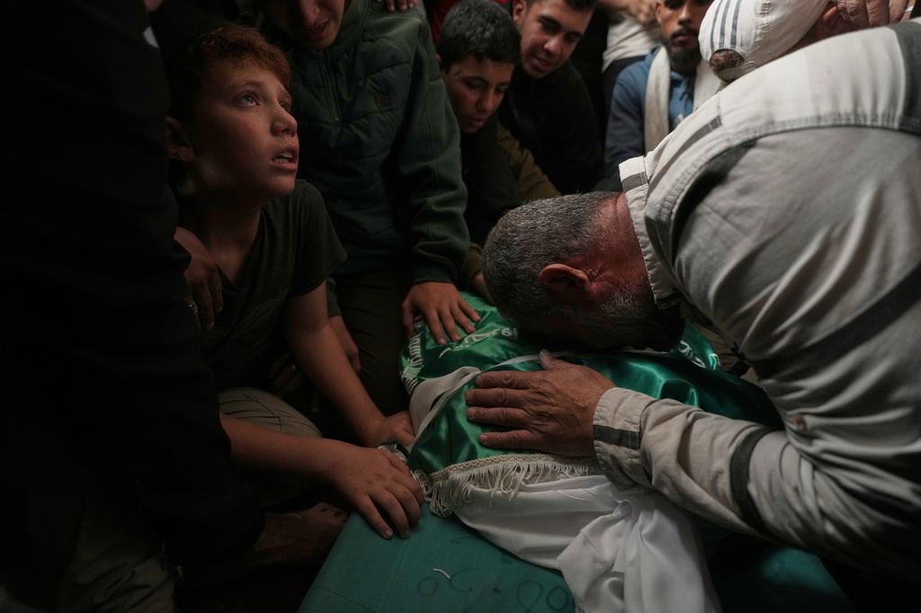 Palestinians mourn over the body of Izz al-Din al-Haddad, the leader of Hamas' Qassam Brigades, during his funeral in Gaza City, Saturday, May 16, 2026. (AP Photo/Jehad Alshrafi)