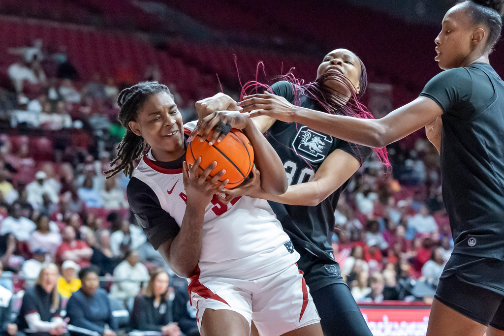 Alabama forward Alancia Ramsey (32) and South Carolina forward Maryam Dauda (30) battle for a rebound during the first half of an NCAA college basketball game Thursday, Feb. 19, 2026, in Tuscaloosa, Ala. (AP Photo/Vasha Hunt)