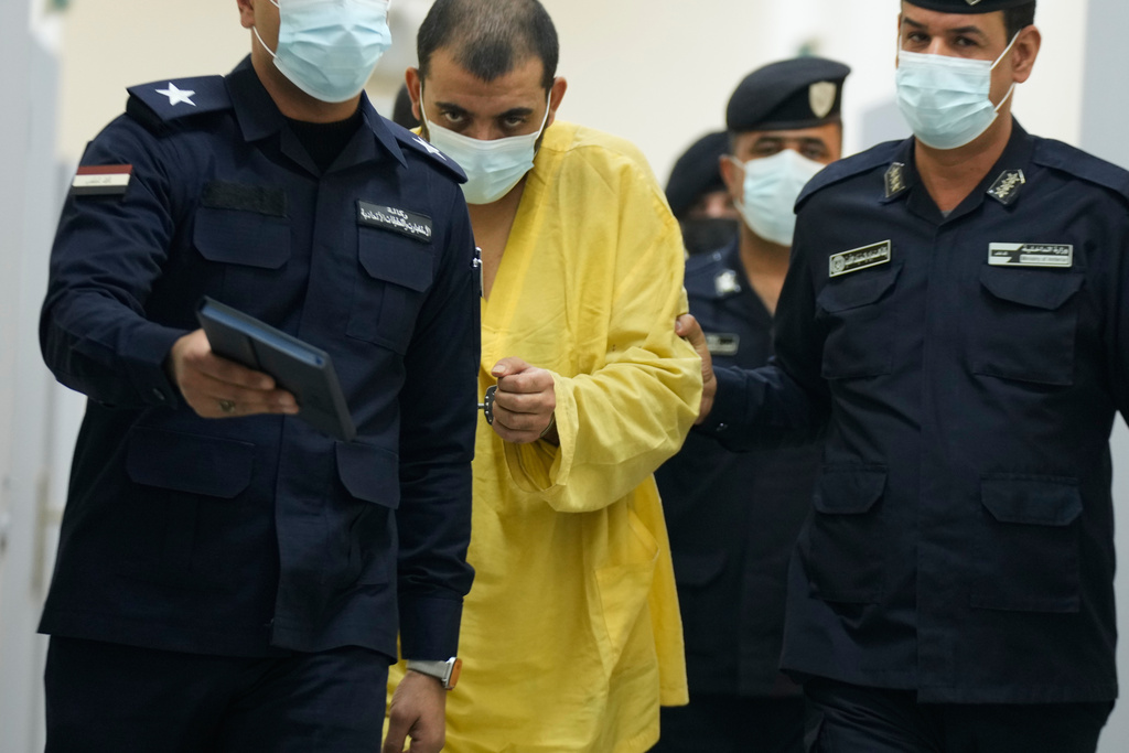 Iraqi security forces lead suspected Islamic State militants for questioning, after they were transferred from Syria to Iraq, at Al-Karkh Central Prison in Baghdad, Iraq, Thursday, Feb. 12, 2026. (AP Photo/Hadi Mizban)