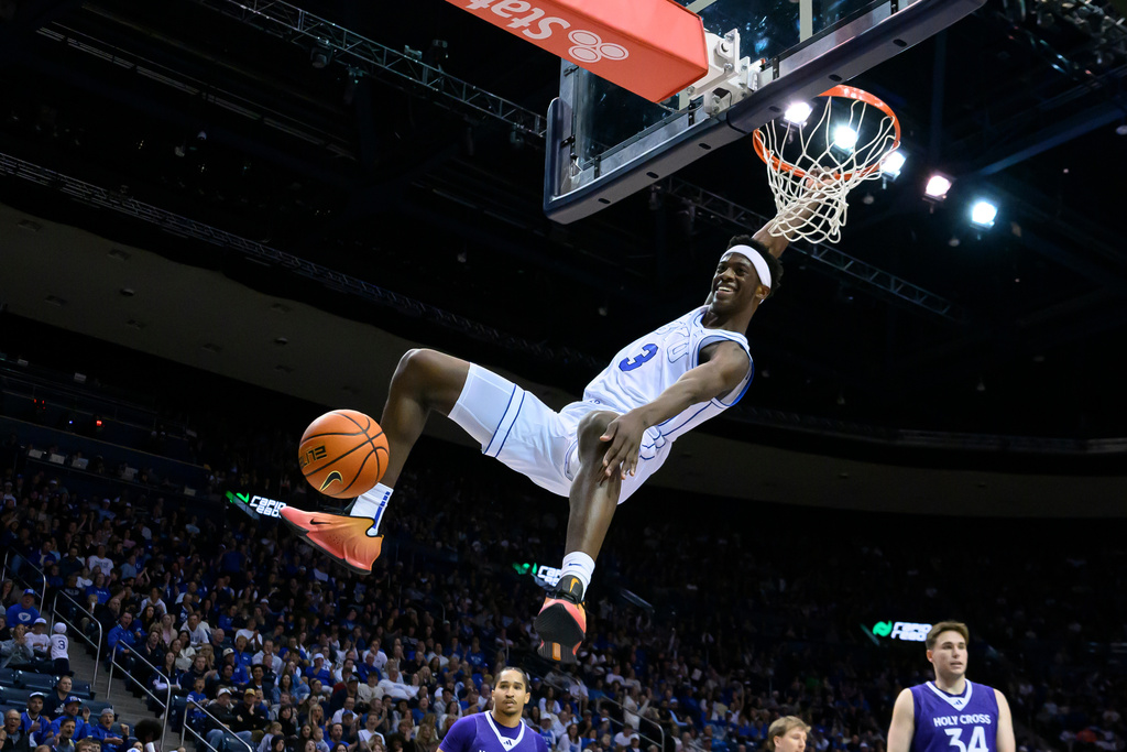 BYU forward AJ Dybantsa (3) dunks the ball during the first half of an NCAA college basketball game against Holy Cross, Saturday, Nov. 8, 2025, in Provo, Utah. (AP Photo/Tyler Tate)