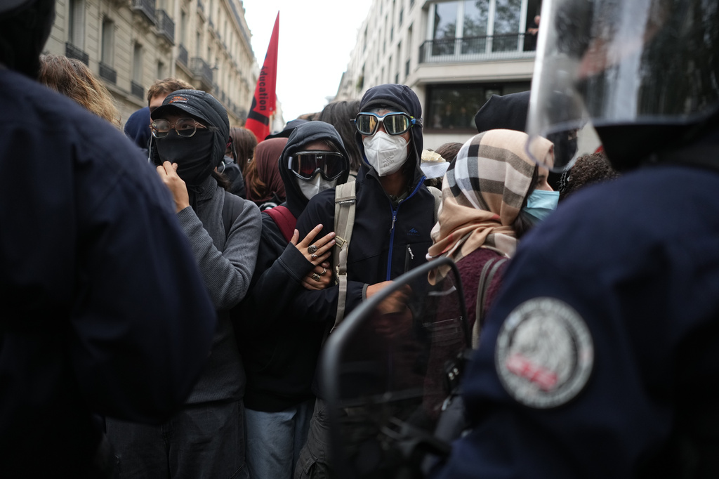 Students face policemen near Sciences Po University as they protest against under-resourced schools, in Paris, Wednesday, Oct. 7, 2026. (AP Photo/Thibault Camus)
