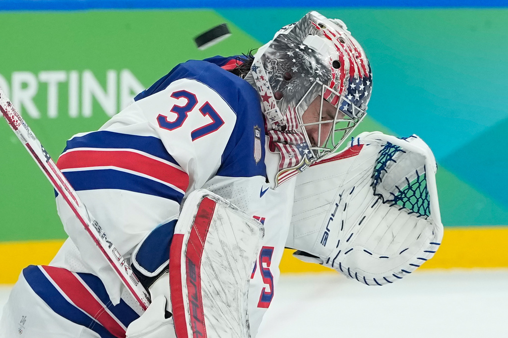 United States' Connor Hellebuyck (37) blocks a shot by Canada during a men's ice hockey gold medal game between Canada and the United States at the 2026 Winter Olympics, in Milan, Italy, Sunday, Feb. 22, 2026. (AP Photo/Petr David Josek)