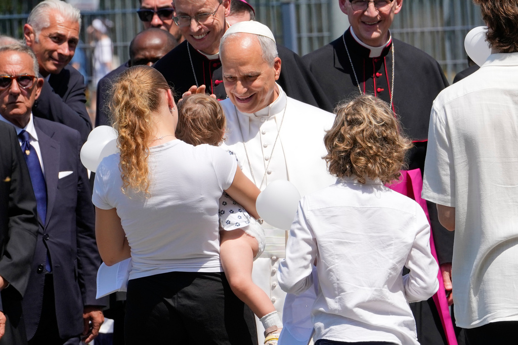 Pope Leo XIV is greeted as he arrives at Pavia, northern Italy, Saturday, June 20, 2026. (AP Photo/Luca Bruno)