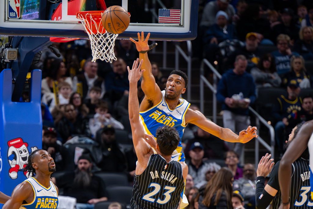 Indiana Pacers center Tony Bradley reaches out to block a shot by Orlando Magic forward Tristan da Silva (23) during the first half of an NBA basketball game in Indianapolis, Wednesday, Dec. 31, 2025. (AP Photo/Doug McSchooler)