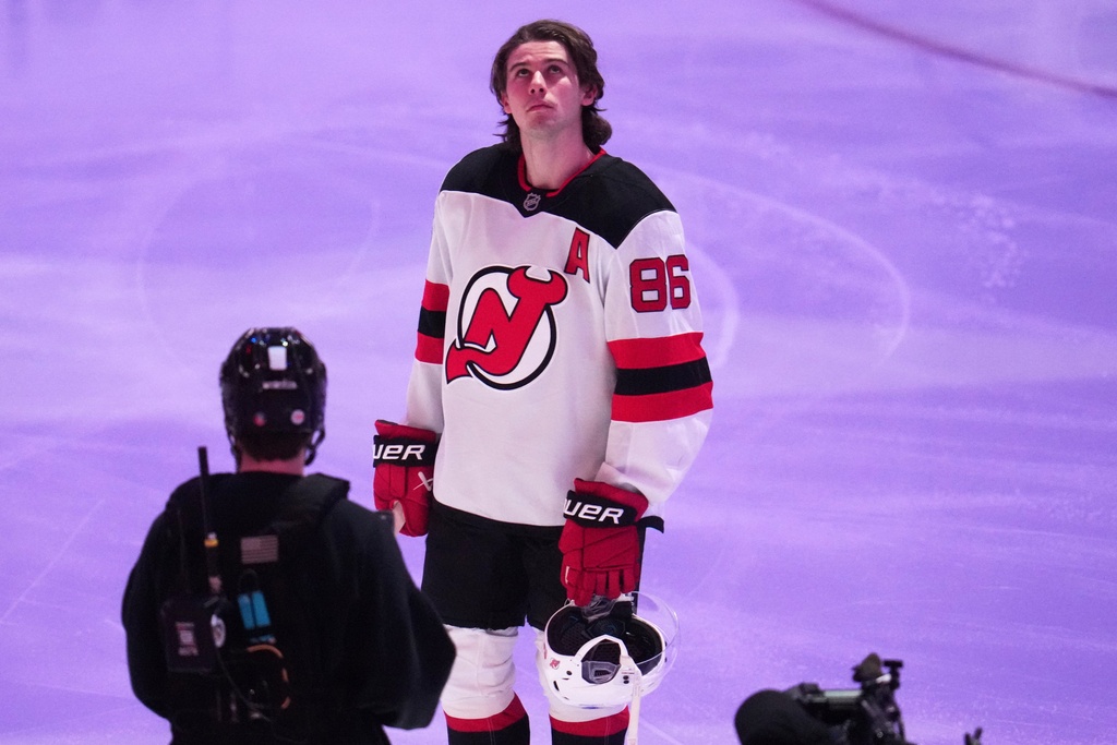 New Jersey Devils' Jack Hughes is honored along with other Olympic hockey players present before an NHL hockey game against the Pittsburgh Penguins in Pittsburgh, Thursday, Feb. 26, 2026. (AP Photo/Gene J. Puskar)