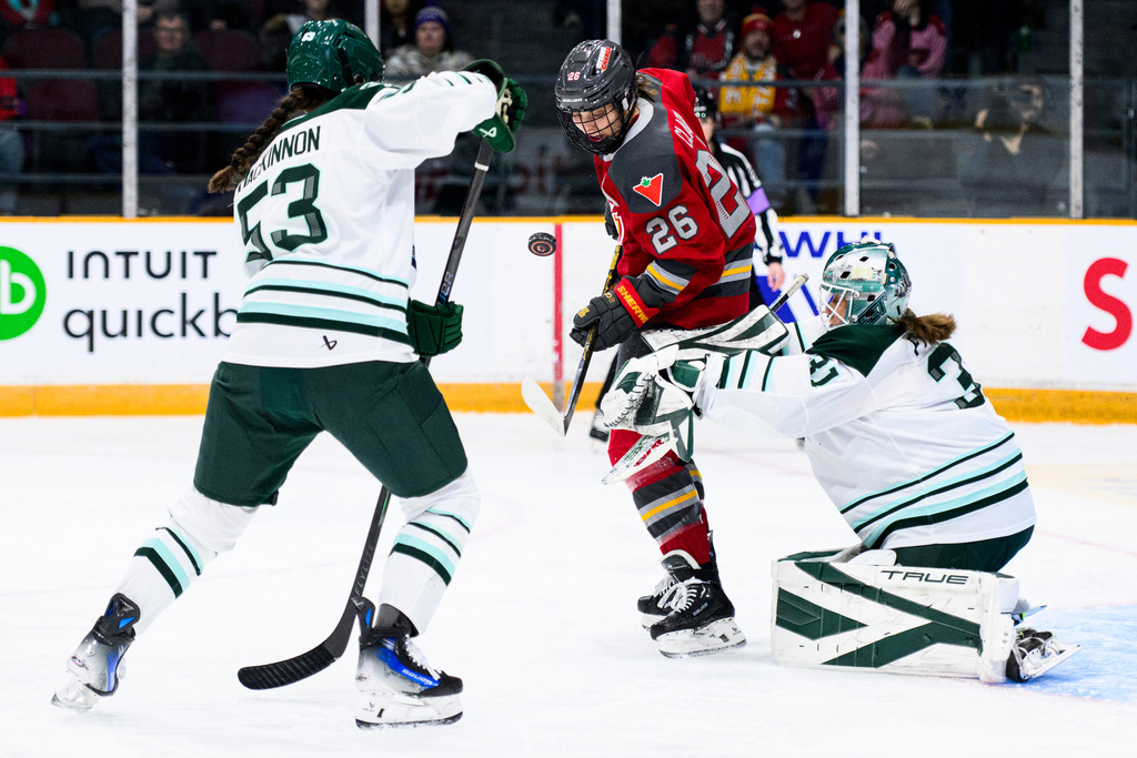 Boston Fleet goaltender Aerin Frankel (31) looks for a save as Ottawa Charge's Emily Clark (26) attacks the net during the first period of an PWHL hockey game in Ottawa, Saturday, Dec. 27, 2025. (Spencer Colby/The Canadian Press via AP)