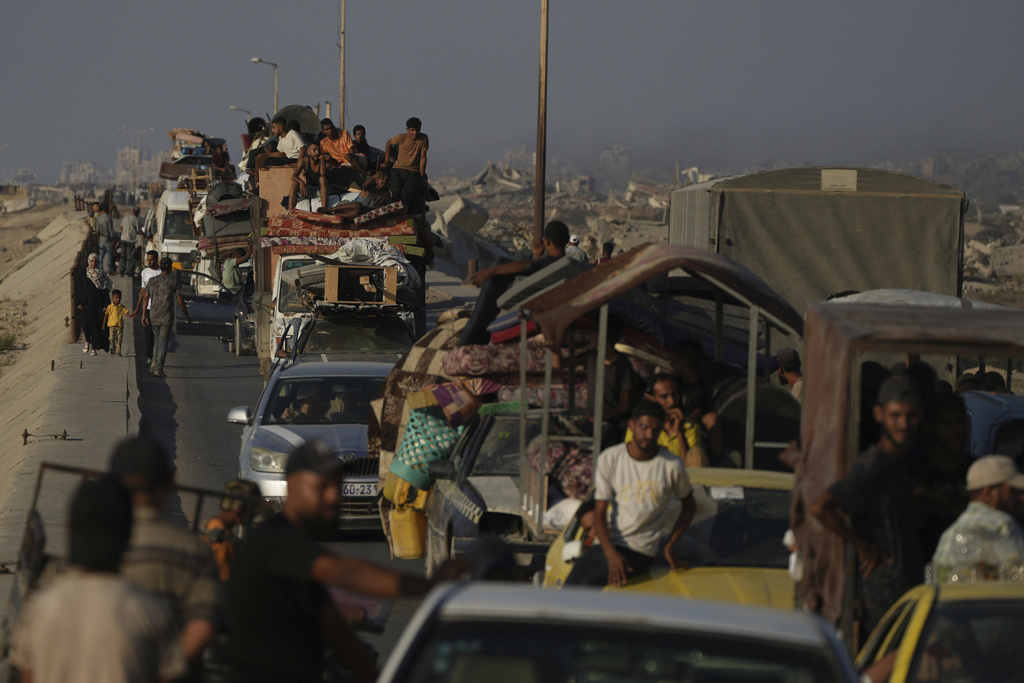 Displaced Palestinians fleeing northern Gaza Strip move with their belongings along the Sea Road, near Wadi Gaza, Saturday, Aug. 30, 2025. (AP Photo/Abdel Kareem Hana)