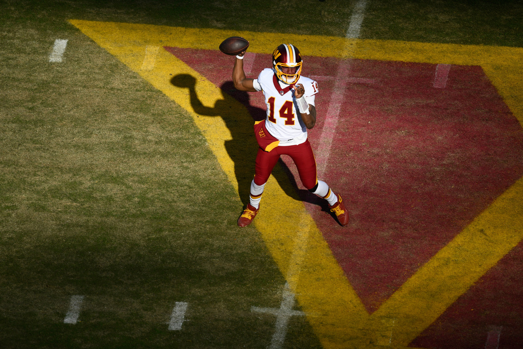 Washington Commanders quarterback Josh Johnson (14) throws during the first half an NFL football game against the Dallas Cowboys Thursday, Dec. 25, 2025, in Landover, Md. (AP Photo/Nick Wass)