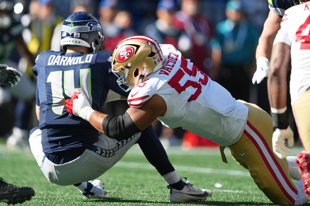 San Francisco 49ers defensive tackle Sebastian Valdez (55) sacks Seattle Seahawks quarterback Sam Darnold (14) during the first half of an NFL football game Sunday, Oct. 11, 2026, in Seattle. (AP Photo/Lindsey Wasson)