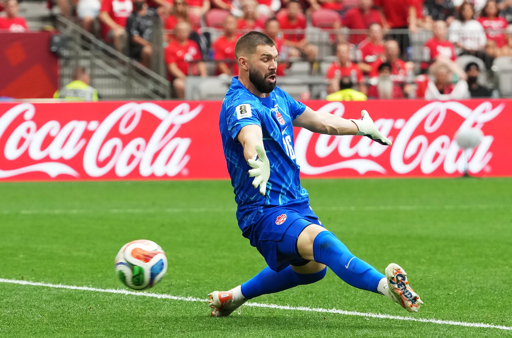 Canada goalkeeper Maxime Crepeau (16) is scored on by Switzerland's Ruben Vargas during the World Cup Group B soccer match between Switzerland and Canada in Vancouver, British Columbia, Wednesday, June 24, 2026. (Ethan Cairns/The Canadian Press via AP)