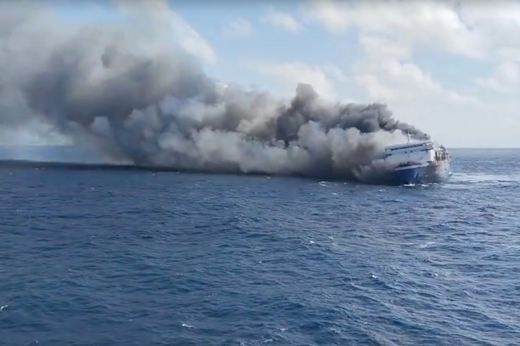 In this photo made from video released by the Indonesian National Search and Rescue Agency (BASARNAS) on Sunday, Aug. 2, 2026, smoke billows from passenger ship Mutiara Santosa 2 after it caught fire in the waters off Madura Island, Indonesia. (BASARNAS via AP)