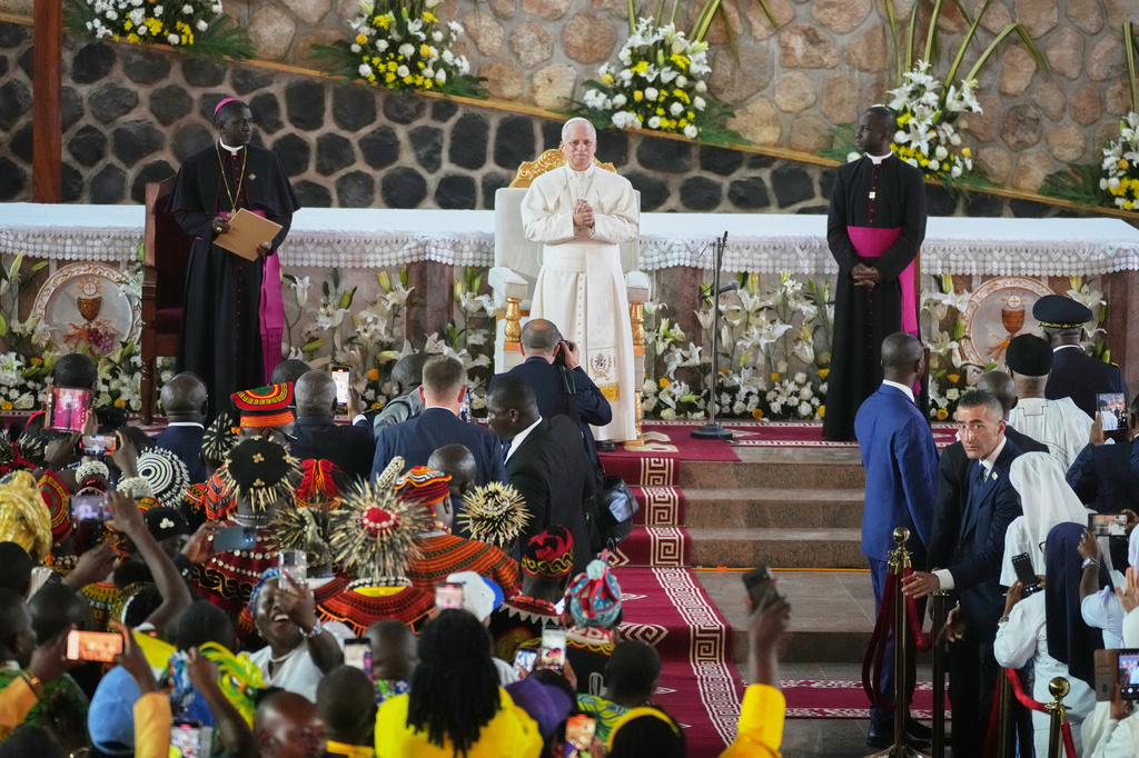 Pope Leo XIV, with the Archbishop of Bamenda, Andrew Nkea Fuanya, left, leads a meeting for peace at Saint Joseph's Cathedral in Bamenda, Cameroon, with the local community Thursday, April 16, 2026, on the fourth day of his 11-day pastoral visit to Africa. (AP Photo/Andrew Medichini)