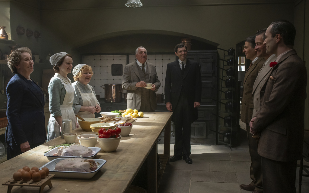 This image released by Focus Features shows Phyllis Logan, Sophie McShera, Lesley Nicol, Jim Carter, Michael Fox, Robert James-Collier, Dominic West, and Arty Froushan in a scene from "Downton Abbey: The Grand Finale." (Focus Feature via AP)