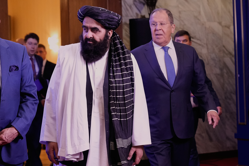 Afghanistan's Foreign Minister Amir Khan Muttaqi, left, and Russian Foreign Minister Sergey Lavrov arrive to pose for a photo prior to their talks on the sidelines of the Moscow format consultations on Afghanistan in Moscow, Russia, Tuesday, Oct. 7, 2025. (AP Photo/Alexander Zemlianichenko)