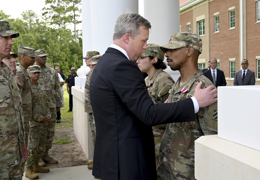Army Secretary Dan Driscoll comforts Sergeant Aaron Turner after Turner received the Meritorious Service Medal with five other soldiers outside Fort Stewart in Georgia, Thursday, Aug. 6, 2025. (Hyosub Shin /Atlanta Journal-Constitution via AP)