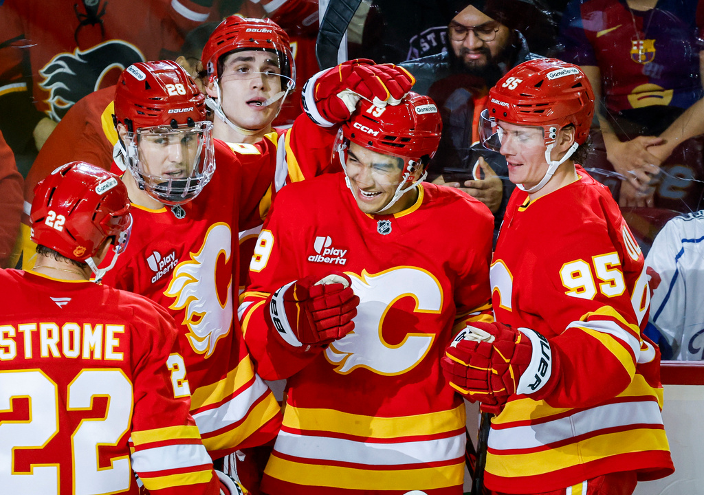 Calgary Flames' Zayne Parekh (19) celebrates his goal with teammates during the third period of an NHL hockey game against the Los Angeles Kings in Calgary, Thursday, April 16, 2026. (Jeff McIntosh/The Canadian Press via AP)