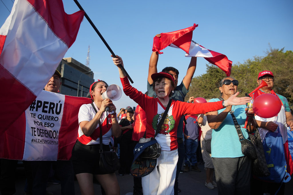 Supporters of presidential candidate Rafael Lopez Aliaga, of the Popular Renewal party, rally in Lima, Peru, Sunday, April 19, 2026. (AP Photo/Guadalupe Pardo)