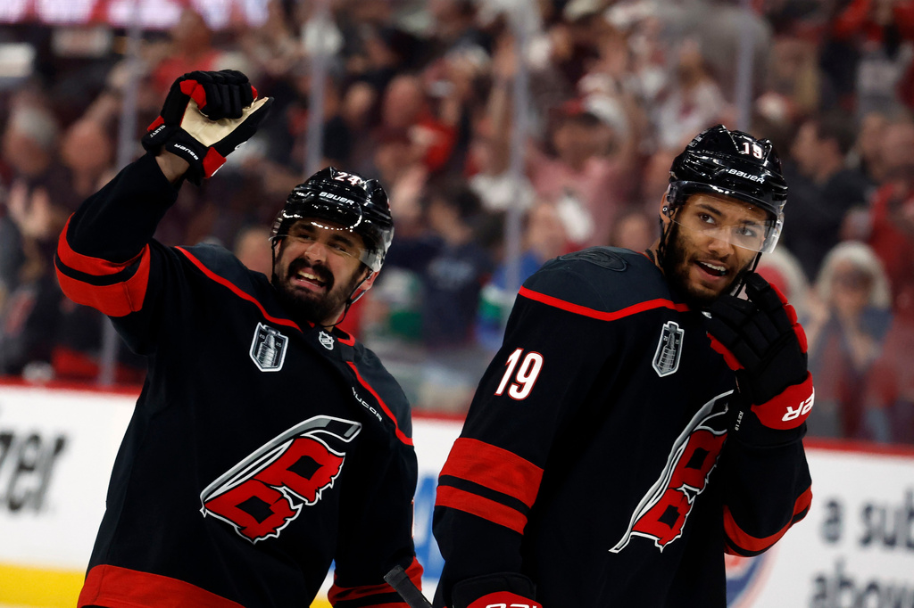 FILE - Carolina Hurricanes' Seth Jarvis (24) and K'andre Miller (19) wave to family following Game 2 of the NHL hockey Stanley Cup Final series against the Vegas Golden Knights in Raleigh, N.C., Thursday, June 4, 2026. (AP Photo/Karl DeBlaker, File)
